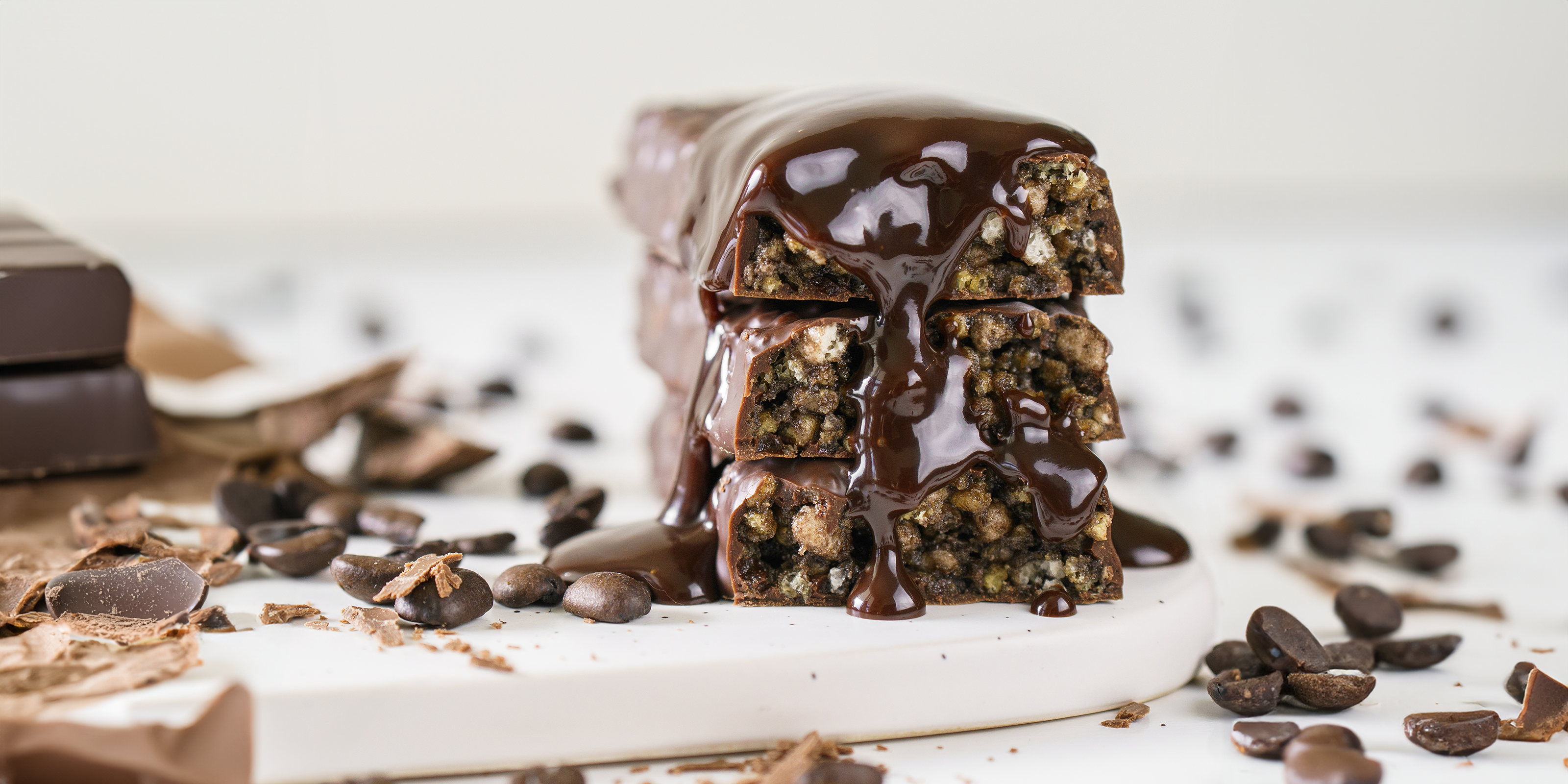 Dark Chocolate Drizzle on Chocolate Protein Bar surrounded by Chocolate Chips