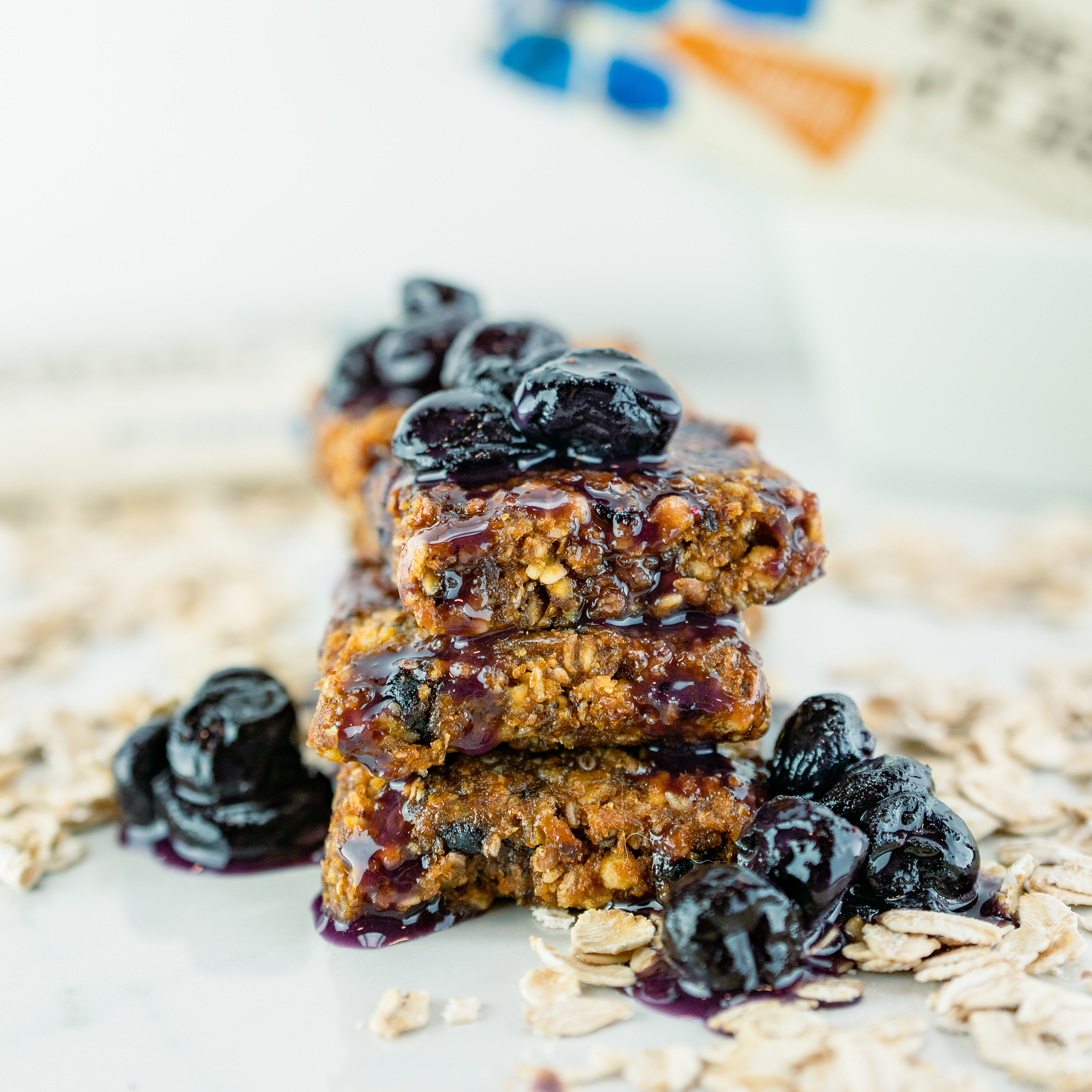 nuGo Fiber Blueberry Cobbler bar unwrapped, cut into pieces and stacked then drizzled with blueberry sauce and oats