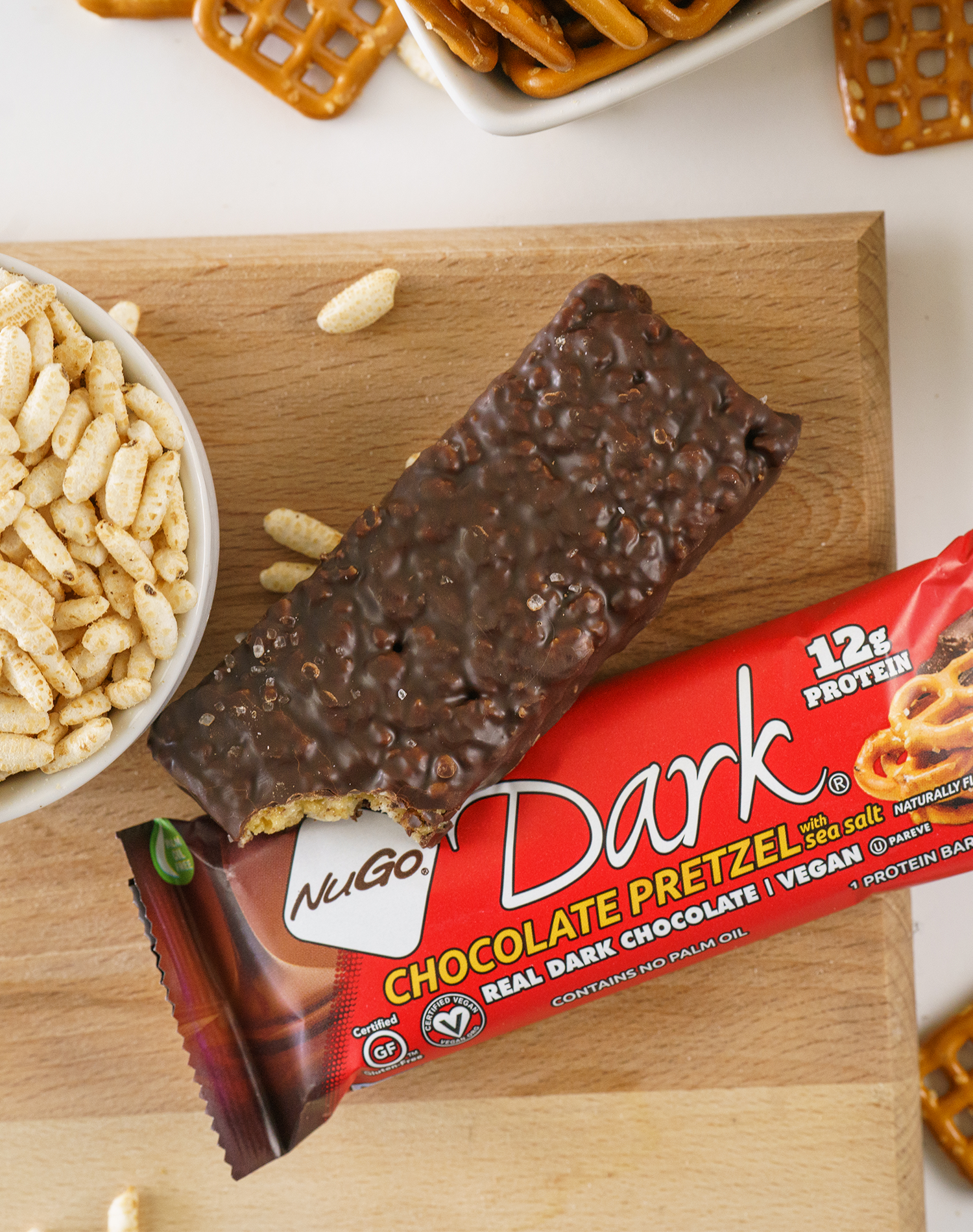 NuGo Dark Chocolate Pretzel Bar surrounded by Ingredients