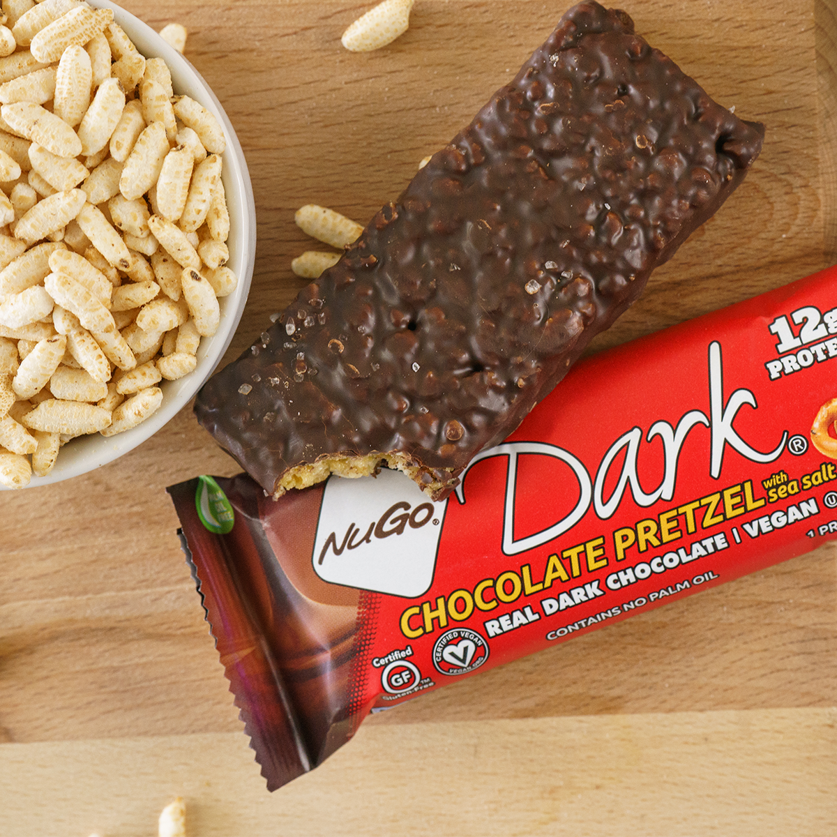 NuGo Dark Chocolate Pretzel wrapped bar with a second unwrapper bar with a bite out of it