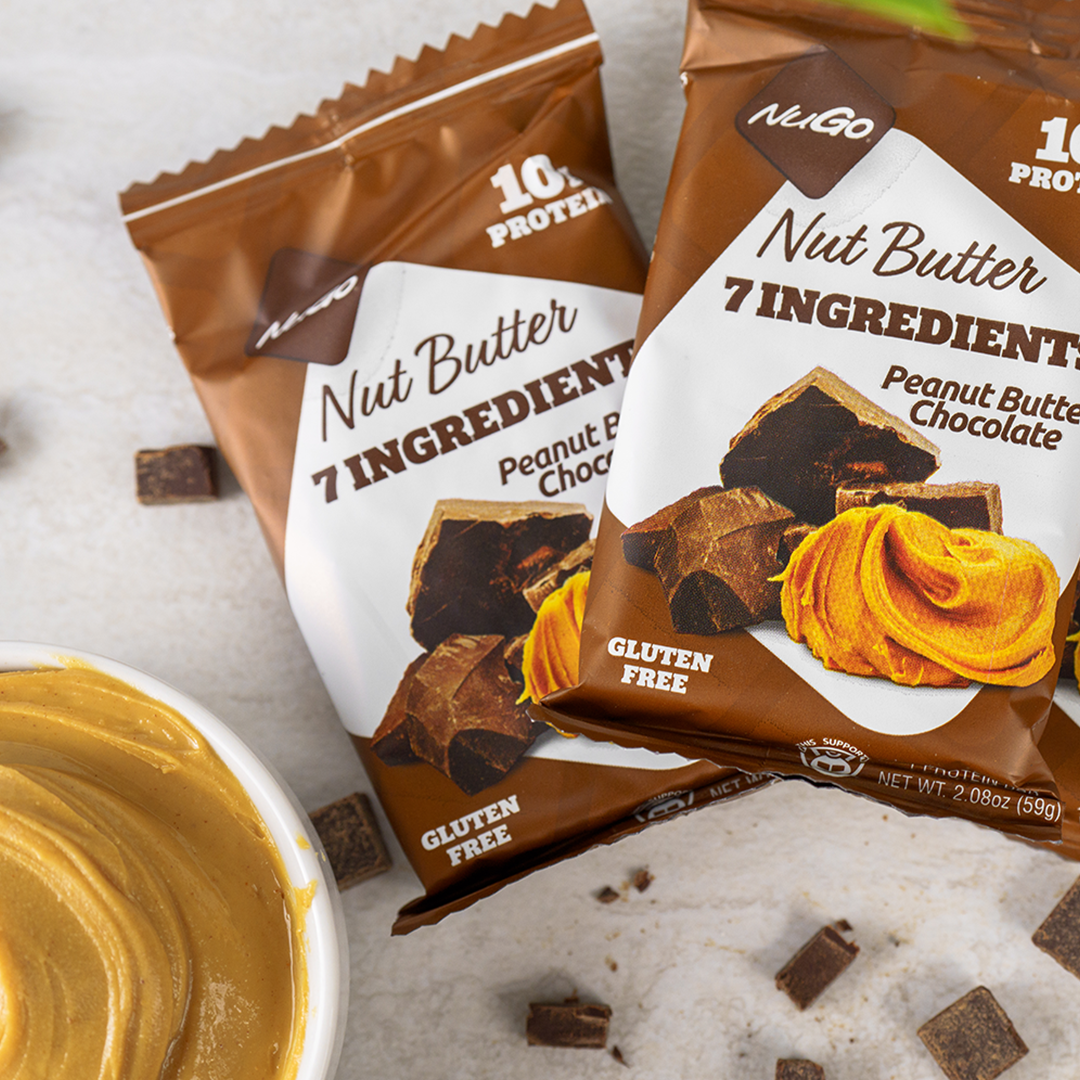 2 NuGo Nut Butter Peanut Butter Chocolate bars with a bowl of peanut butter