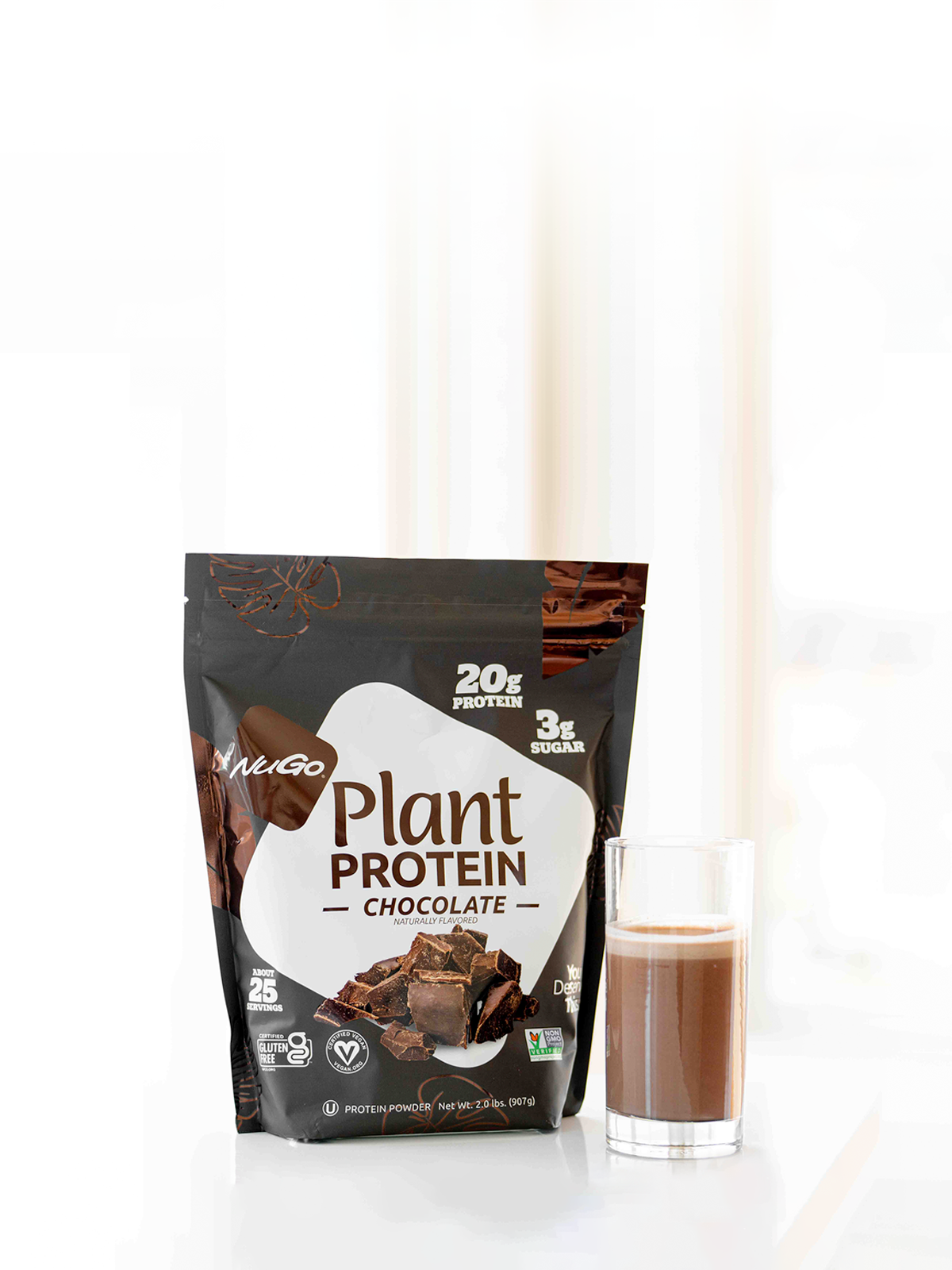 NuGo Protein Powder bag with tall glass of mix to the right