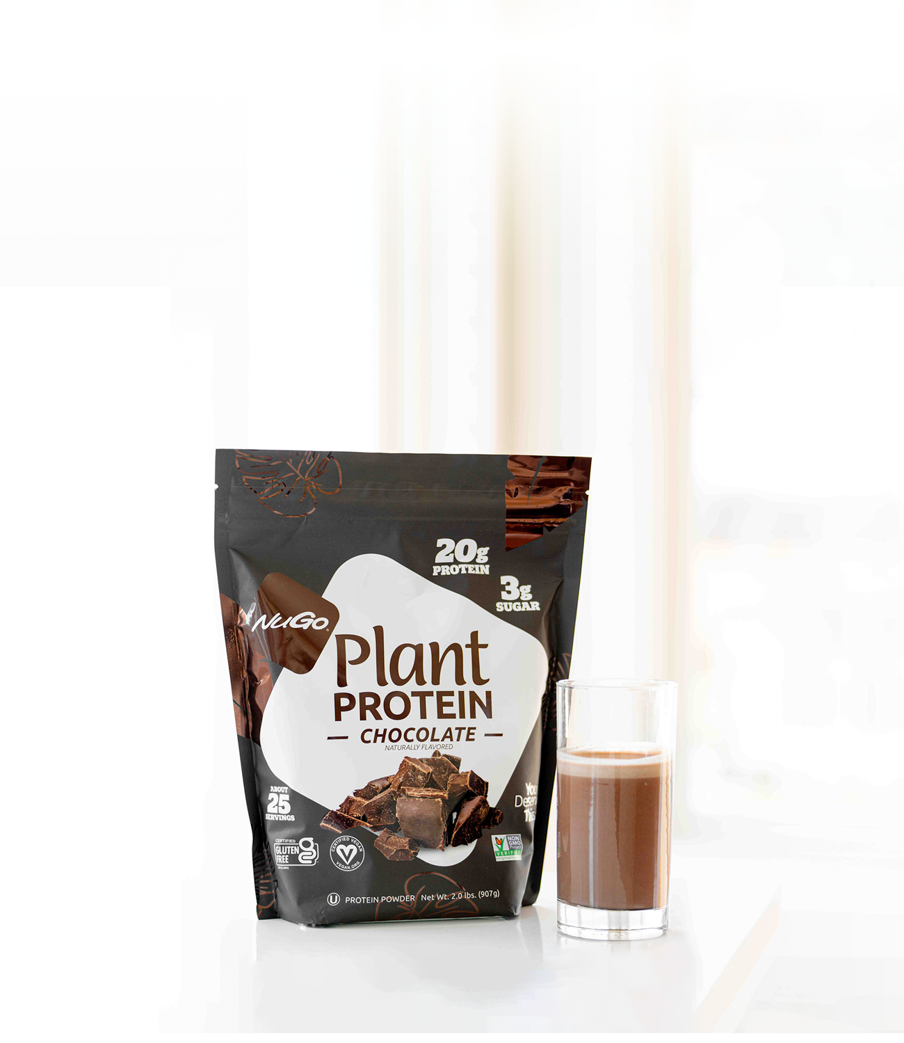 NuGo Protien Powder Chocolate next to tall glass with product inside