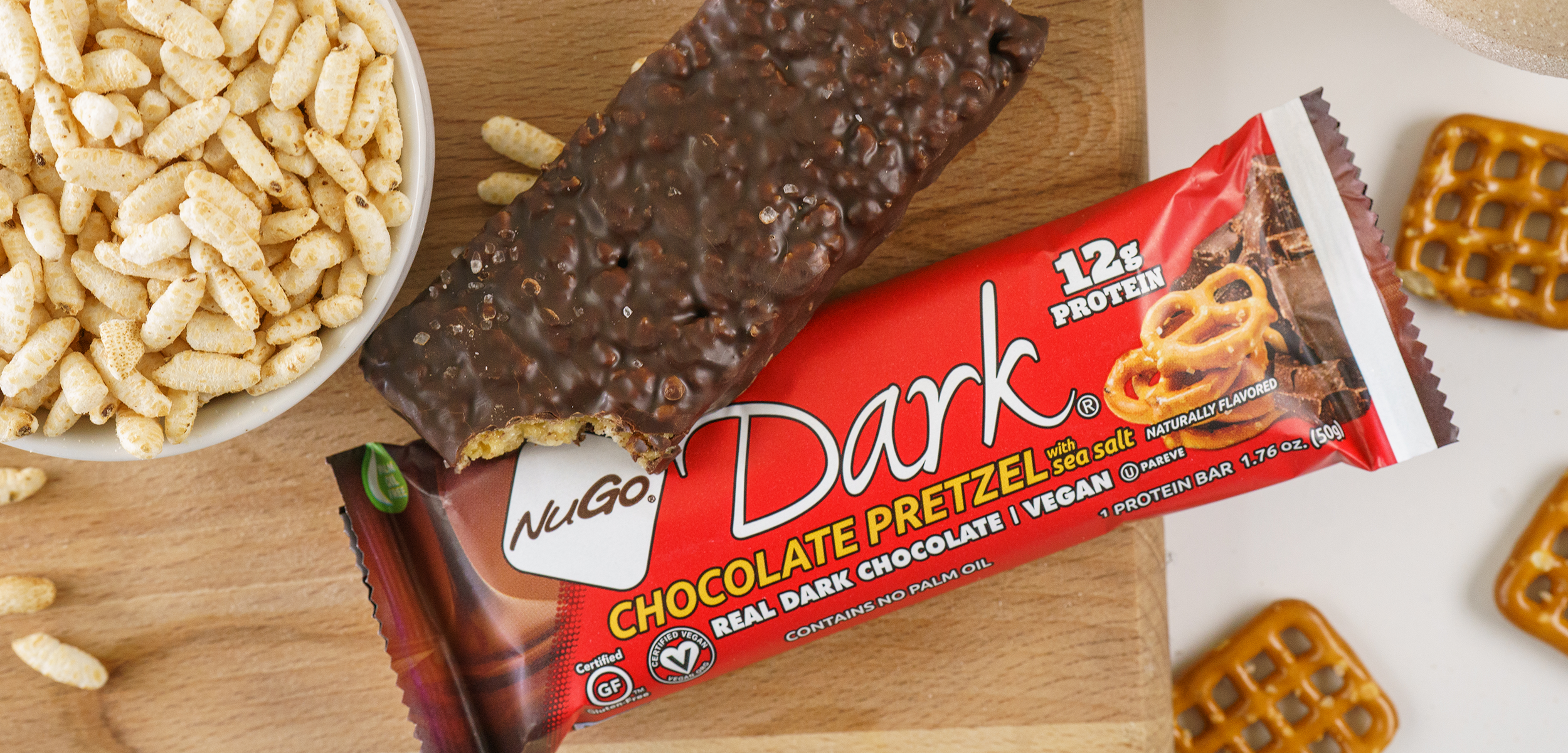 NuGo Dark Chocolate Pretzel Bar surrounded by Ingredients
