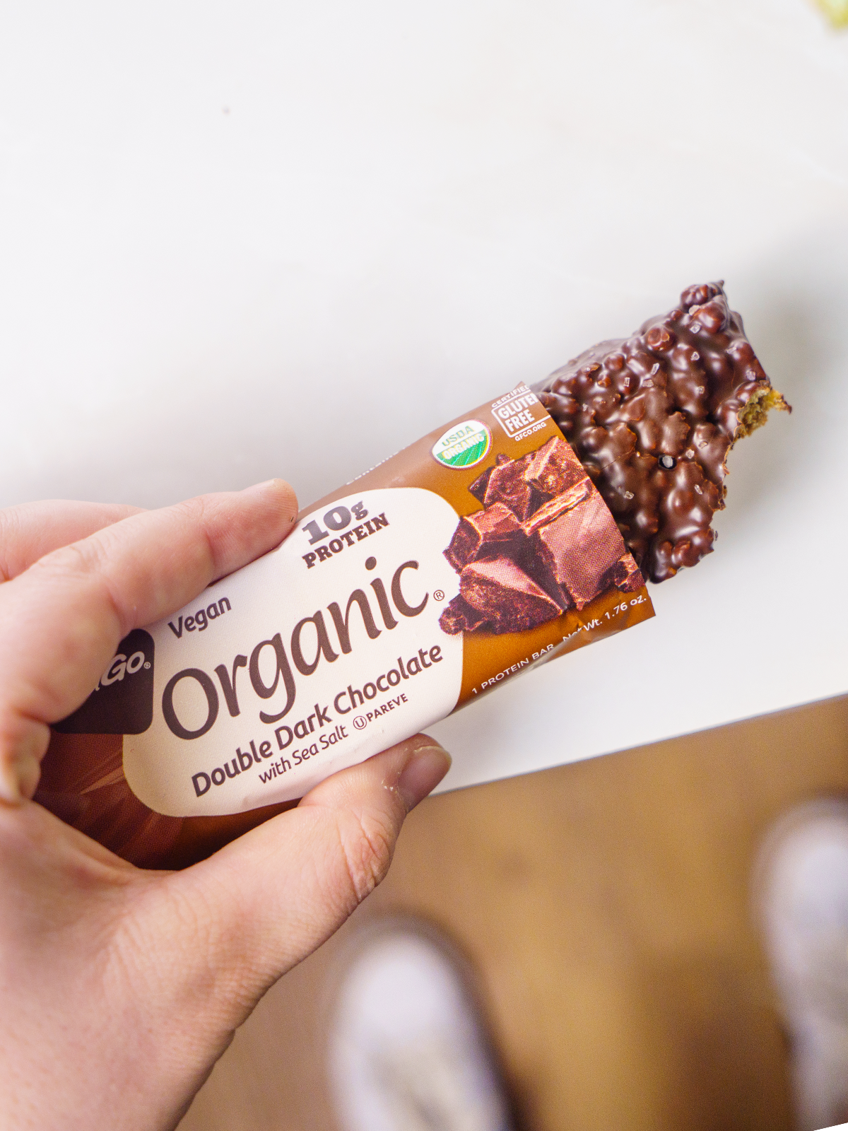 Close up NuGo Organic Double Dark Chocolate in hand